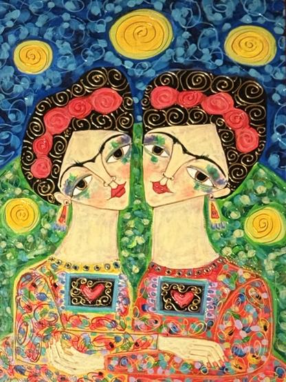 A colorful, stylized painting of two women with similar features, adorned in vibrant traditional dresses. They have floral headdresses and glasses, gazing affectionately at each other, set against a bright blue background with golden suns.