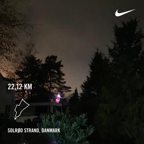 Santa Claus on top of a roof, shining brightly like a diamond against the dark shadows of trees.