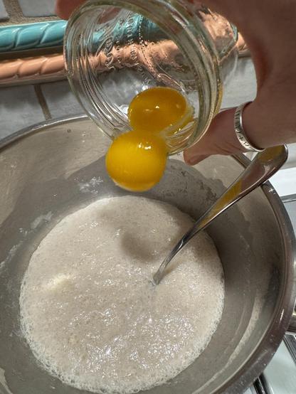 Adding two egg yolk to the yeast starter, not shown: 60g melted butter also in the bowl