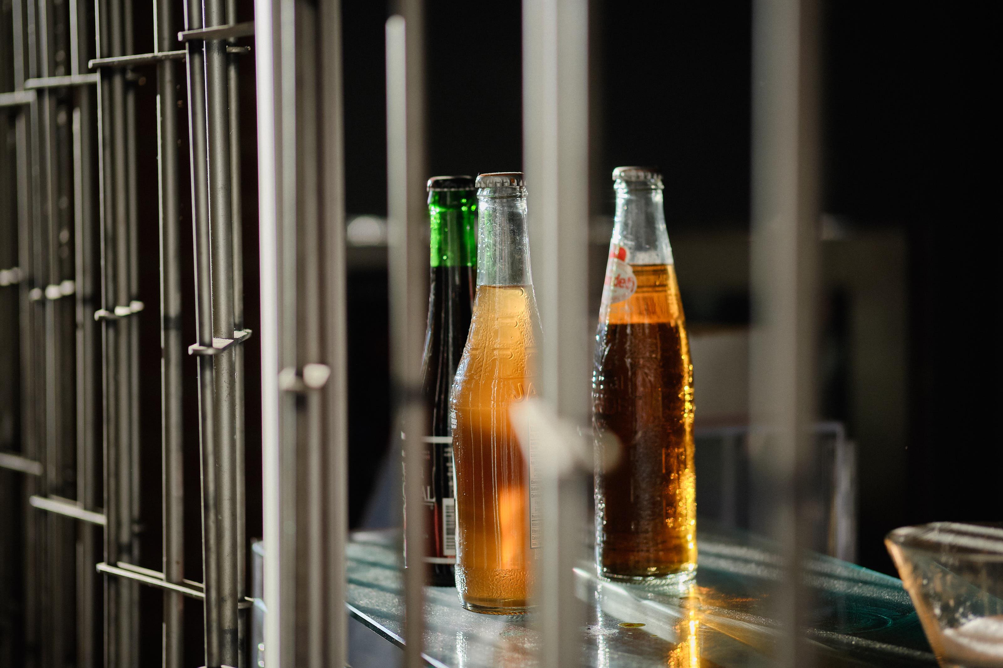 Glass soda bottles behind bars in a closed stall at the Jean Talon market.