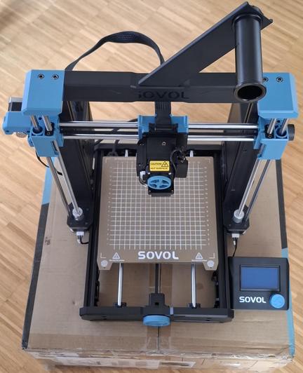 A SOVOL 3D printer standing on a cardboard box.