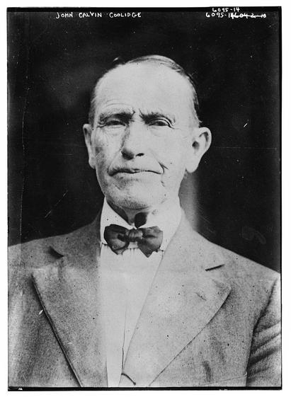The image is a black-and-white portrait of a man, likely taken in the early to mid-20th century, judging by the style of the photograph and the man's attire. The man is wearing a formal suit with a white shirt and a dark bow tie. His hair is neatly combed back, and he has a serious expression on his face. The background is dark and plain, which helps to focus attention on the subject. The photograph appears to be a formal portrait, possibly for professional or historical purposes. There is text at the top of the image that reads "JOHN CALVIN COOLIDGE," indicating that the subject is John Calvin Coolidge, who served as the 30th President of the United States from 1923 to 1929. The image also has a catalog number "L095-14" and "L095-14042-10" at the top right corner, which suggests it is part of a collection or archive.