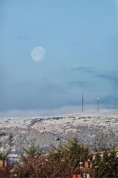 Moon over snowy hills