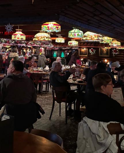 A crowded lunch on Christmas Eve. The restaurant is notable for having many stained glass lampshades. Photo by Robert Emond.