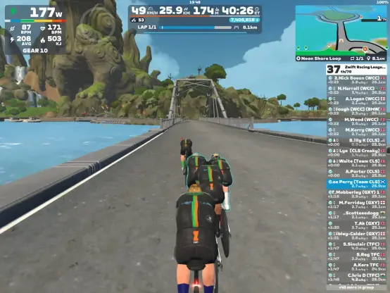 Riders avatars riding in a line while approaching a bridge on Zwift
