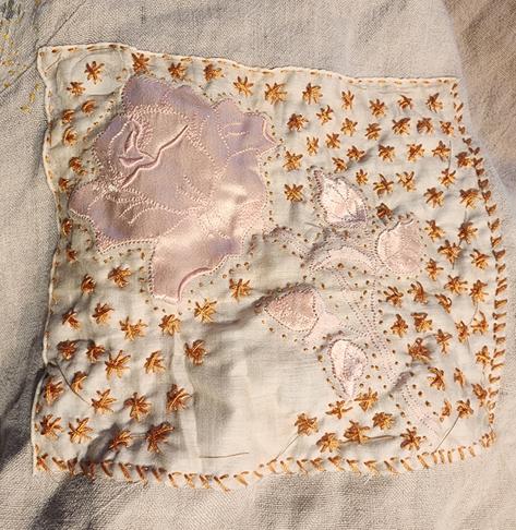 embroidered mending with a vintage cotton patch on a linen smock