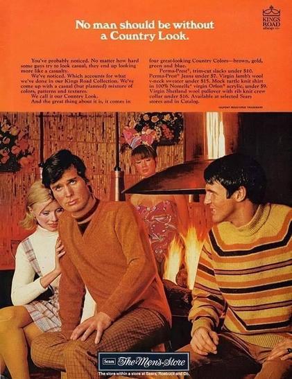 This is a full-page advertisement from around 1969 for The Men’s Store by Sears, Roebuck and Co., promoting the “Country Look” clothing line from the King’s Road Collection. The ad is vertically oriented and dominated by warm autumn colors—rust, brown, gold, and orange.
At the top, against a solid burnt-orange background, large white serif text reads: “No man should be without a Country Look.” Smaller white text below explains the concept of casual but planned men’s fashion, emphasizing coordinated colors, patterns, and textures. The copy references specific garments such as trim-cut slacks, lamb’s wool vests, V-neck pullovers, and crewneck sweaters, along with their prices. In the upper right corner is the King’s Road logo.
The lower two-thirds of the image shows a staged indoor scene resembling a cozy lodge or den. Four young adults—three men and one woman—are arranged around a lit fireplace. All appear white and are dressed in coordinated fall clothing. The men wear knit sweaters in earth tones: one in solid rust brown, another in a striped sweater with brown, gold, and cream bands. They also wear patterned slacks typical of late-1960s men’s fashion. The woman wears a light-colored turtleneck and a sleeveless plaid dress.
Wood-paneled walls, floral decorations, and a copper-toned fireplace hood reinforce the rustic “country” aesthetic. At the bottom center is a dark rectangular logo reading “The Men’s Store,”