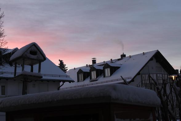 Some buildings at sunrise with snow