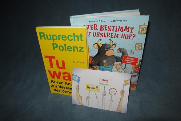 Auf dem Bild seht Ihr die zwei aktuellen Bücher von Ruprecht Polenz "Tu was!" und "Wer bestimmt auf unserem Hof" vor neutralem Hintergrund. 

Im Vordergrund könnt Ihr die extra für beide Bücher gestaltete Signaturkarte unseres Buch-Shops erkennen, auf deren Rückseite sich eine kleine Botschaft des Autors für Euch versteckt.