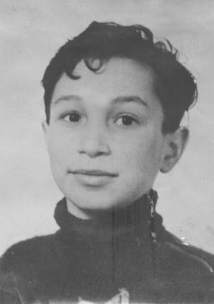 Historical black and white portrait of a boy in a dark turtleneck sweater.