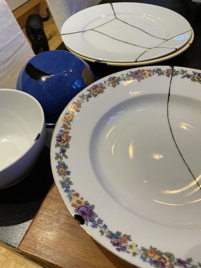 Photo of various plates and bowls with kintsugi repairs