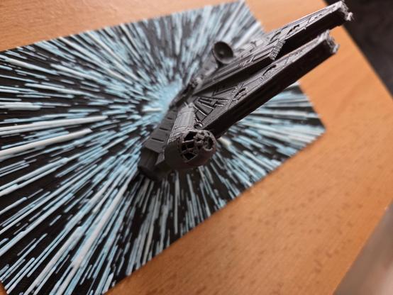 3d printed 2d image of hyperspace lines with a millennium falcon rising from it