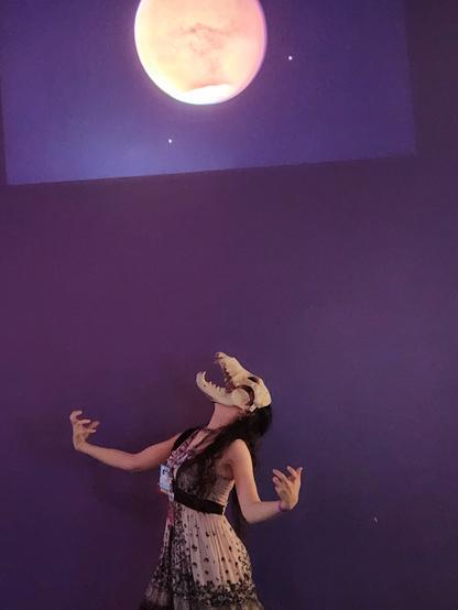 A girl in a skull mask howls