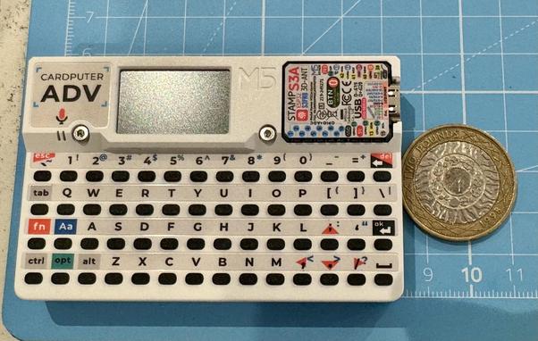 A small Cardputer ADV computer alongside a UK £2 coin ( for size reference)