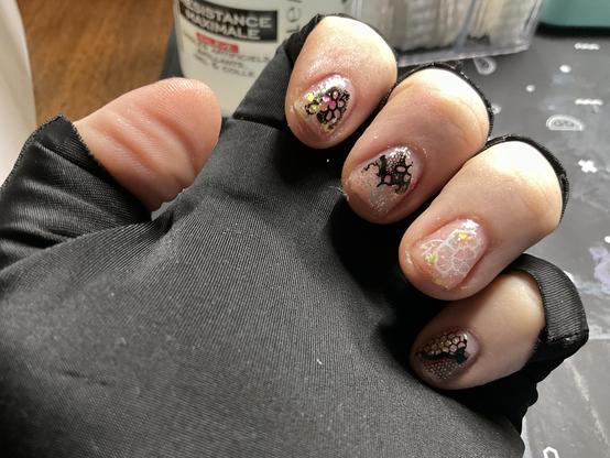 Curled fingers of my left hand with patchy foil