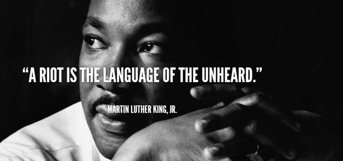 Dr. Martin Luther King, Junior facial closeup and his quote:
"A riot is the language of the unheard."