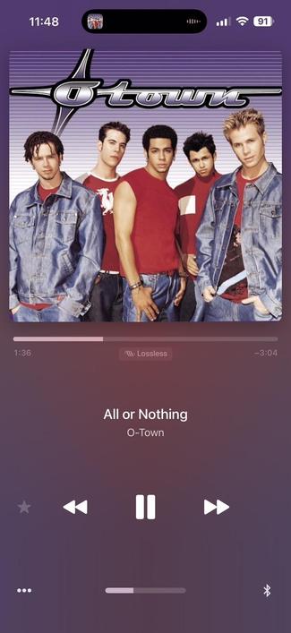 The image displays the album cover for "O-Town," featuring a boy band posed together. The song "All or Nothing" is currently playing, with its playback time shown. The background features a bluish-purple gradient.