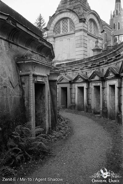 Highgate Cemetery. Gothic crypts line a stone path in black and white with