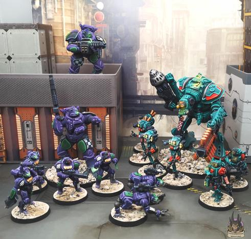 Skirmish scene of Zeo Genesis mechs and troops with Acid House terrain buildings and a Jon Hodson backdrop