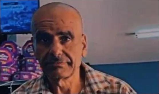 An older man with a bald head and a serious expression stands in a room, wearing a checked shirt. Shelves with products are visible in the background.

Farmer Jibreen Ahmad Jaber Qit, who was critically wounded yesterday by soldiers’ gunfire and later died from his wounds after being denied medical treatment (Photo: WAFA)