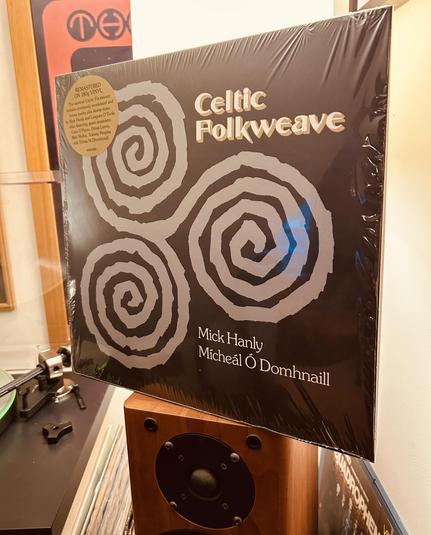 Vinyl record album titled "Celtic Folkweave" by Mick Hanly and Micheál Ó Domhnaill, with a black cover featuring white spiral designs.