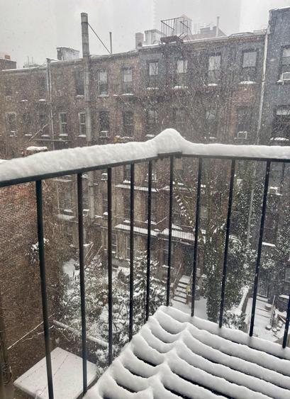 My fire escape and neighbors across the gardens. Snow piling up.