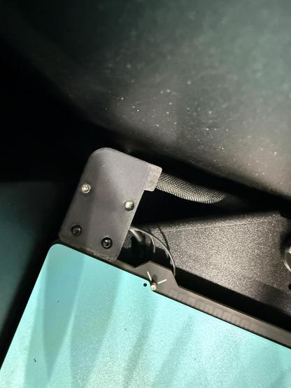 A top down shot of the heat bed wiring cover. One of the screws looks very strange.