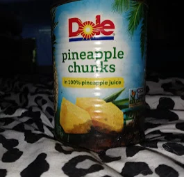 image of a can of dole pineapple chunks where the bottom is rusted through