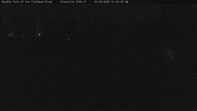 The Middle Fork of the Flathead River forms the southwest border of Glacier National Park. This view, from near Park Headquarters, shows the river as it flows under the West Glacier bridge. At night some of the lights of West Glacier may be visible. During the summer, watch for rafters. Several commercial rafting businesses use this section of river. In the winter, the only activity along the river might be the occasional coyote or deer or a really cold kayaker.