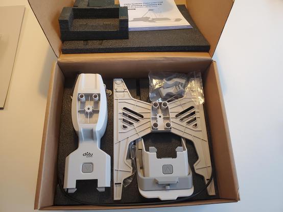 An open box with intriguing 3d printer parts inside.