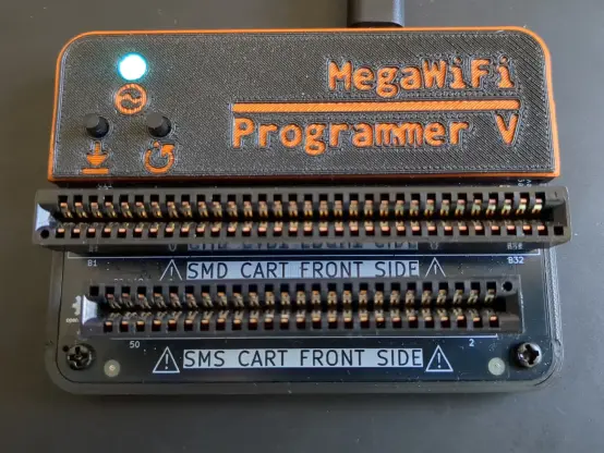 Photograph of the MegaWiFi programmer V from the top. It is plugged and the LED pipe is lighting in clear green color.