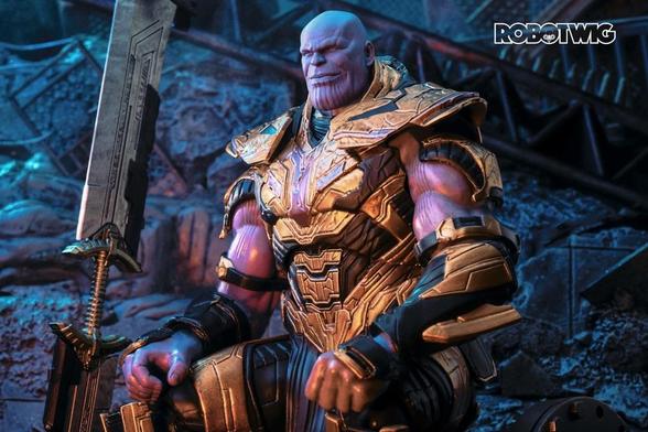 Thanos sits down by rubble smiling