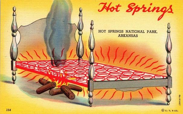 An illustrated novelty postcard labeled “Hot Springs” and “Hot Springs National Park, Arkansas.” The image shows a wooden bed frame raised on turned posts. Instead of a mattress, the bed surface is depicted as a glowing red grill with circular patterns, emitting heat waves and steam. Beneath the bed, logs are stacked and shown burning like a fire, suggesting the bed is heated from below. Red heat lines radiate around the bed, visually emphasizing warmth. The background is a warm yellow gradient. A small copyright mark reads “© C. T. & Co.” with a printed number “164” in the lower left corner.