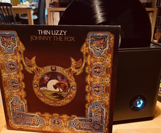 Album cover for Thin Lizzy's "Johnny the Fox" with a vinyl record spinning in the cleaner beside it.