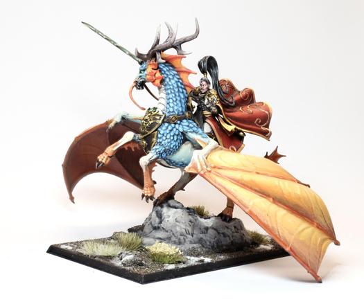 A Cathayan Shugengen General on Great Spirit longma (dragon-horse), the general has a billowing red and gold cape, the dragon horse has white skin, blue scales, orange wings and fins.