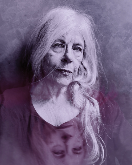 Selfie of a silver haired white woman, with a mirror image of her face at the bottom of the picture.