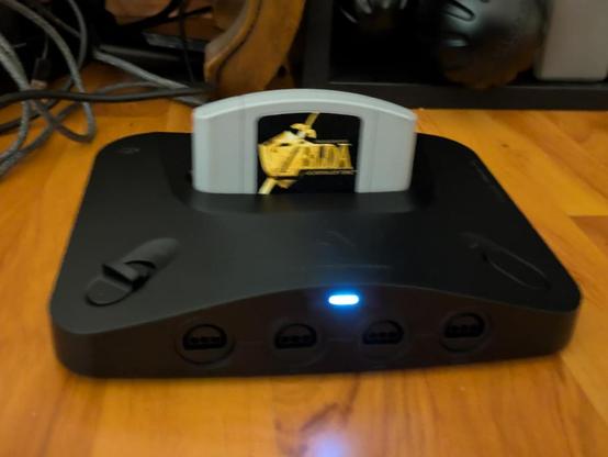 Terrible photo of  a Analogue 3D console with a PAL Ocarina of Time module inserted.