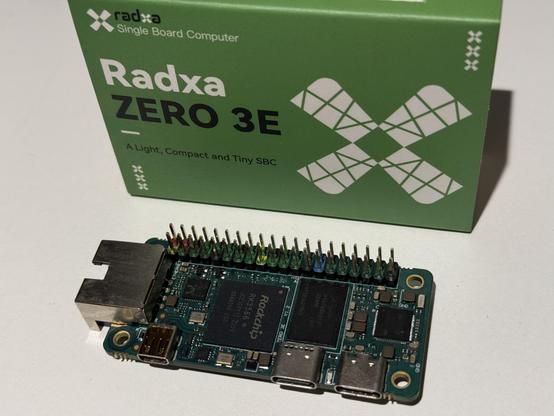 Image of Radxa Zero 3E next to its retail box.