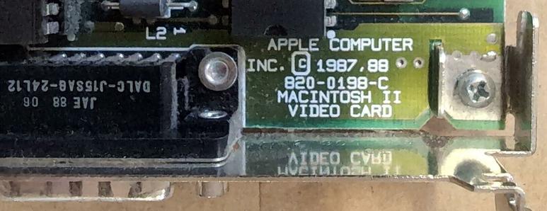 A closeup of the corner of the card above the D-sub connector. Printed on the board is APPLE COMPUTER INC, COPYRIGHT 1987, 88 820-0198-C MACINTOSH II VIDEO CARD.