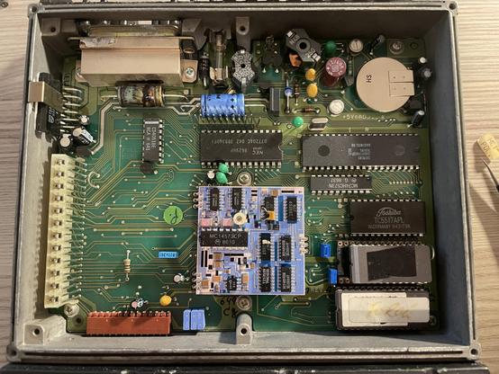 Top of the "Common Function Board" - an 8000ish looking CPU, some RAM, two UV eraseable PROMs...