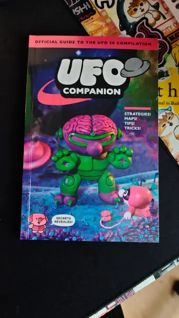 Photo of the official UFO 50 companion guide.