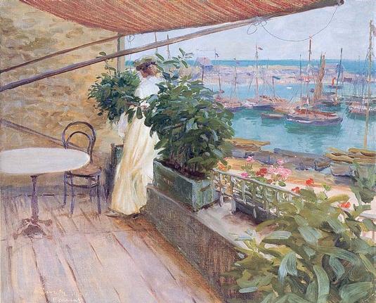 Woman in white dress on a balcony. Staring at blue water with small sailing ships in harbour.