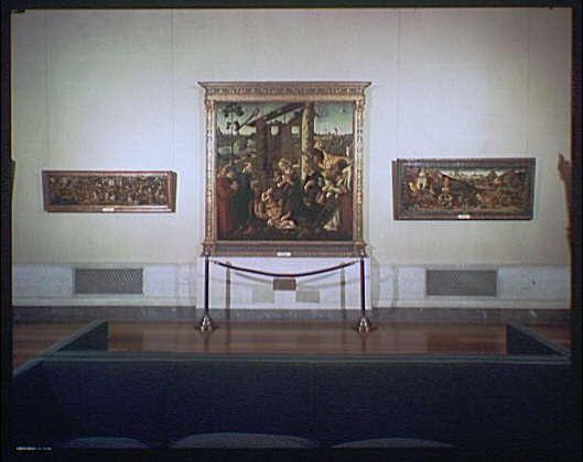 The image depicts a large painting titled "Nativity" displayed within an art gallery setting, with the main piece centrally positioned on a wall. The artwork is surrounded by protective railings and mounted in what appears to be a museum-like environment. Two additional smaller paintings are visible on either side of the central work.

Additional information provided indicates that this particular depiction was captured around 1920-1950, suggesting it's likely an archival photograph or similar media from that era. The artist responsible for creating "Nativity" is identified as Horydczak, with his estimated lifespan ranging approximately between the years of 1890 and 1971.

The image source link provided (https://images.loener.nl/horydczak/full/691e/691ec696450e57a2674cf482.jpg) further corroborates the context of this artwork within a gallery, with specific details pointing towards its historical and artistic significance.