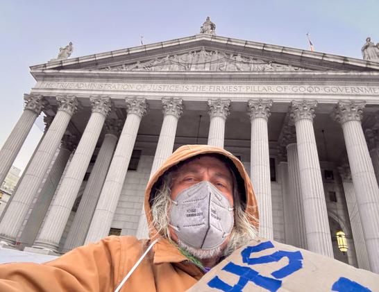 Selfie with huge courthouse behind me. Edge of my sign is visible.