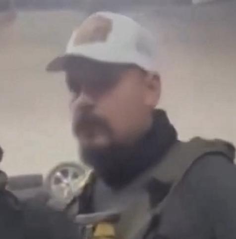 Close-up from video of ICE agents.