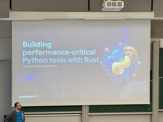 Photo of a screen slide showing the title of the talk: Building performance-critical Python tools with Rust
