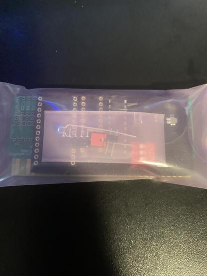 Front of the package showing parts in the package. High quality sockets for a Dallas RTC and programmed chips.