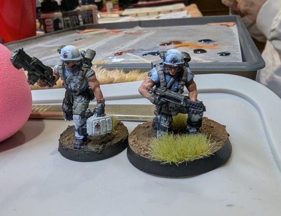 Two science fiction medics models painted in blueish white armor. Both are from Papsikels models.