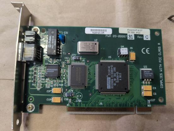 A PCI card with external 8P8C jack and LEDs. A sticker reading AsanteFast 10/100 PCI is on the upper right corner. Below that PWA 09-00087 is screenprinted on the board with 31 stamped in ink. Rev is screenprinted with C stamped in ink.