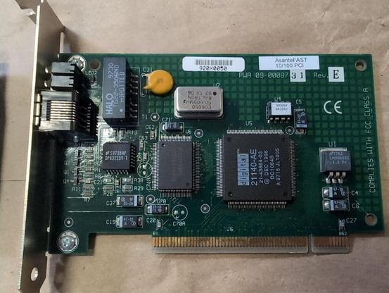 A PCI card with external 8P8C jack and LEDs. A sticker reading AsanteFast 10/100 PCI is on the upper right corner. Below that PWA 09-00087 is screenprinted on the board with 31 stamped in ink. Rev is screenprinted with E stamped in ink.